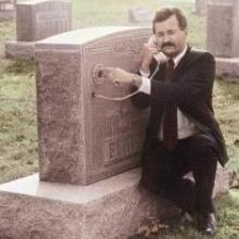 Homem telefonando no túmulo